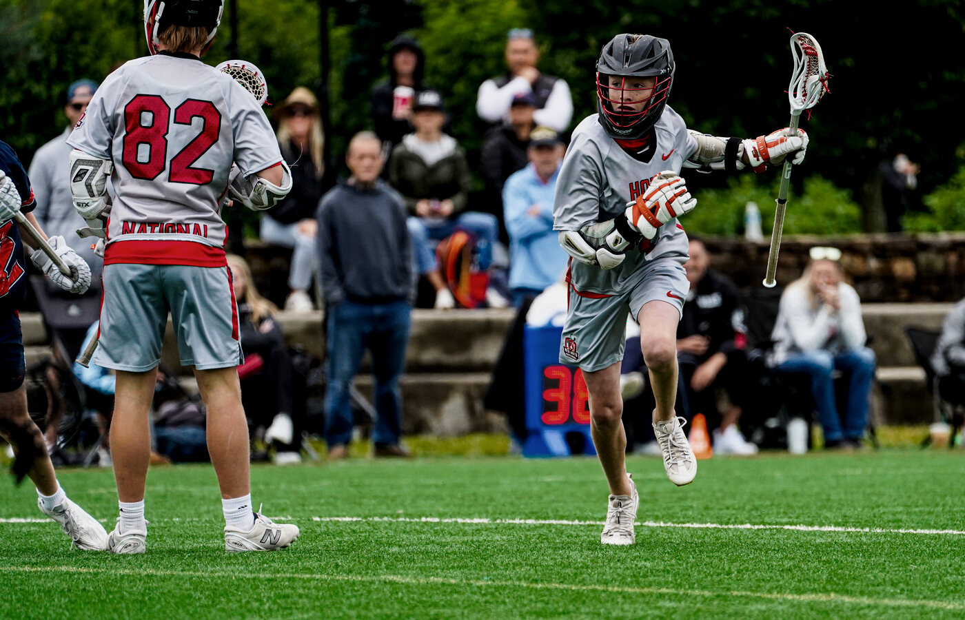 Two club lacrosse players battling for possession.